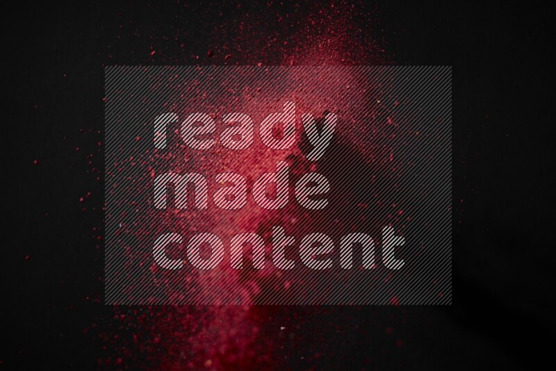 Red powder explosion on black background