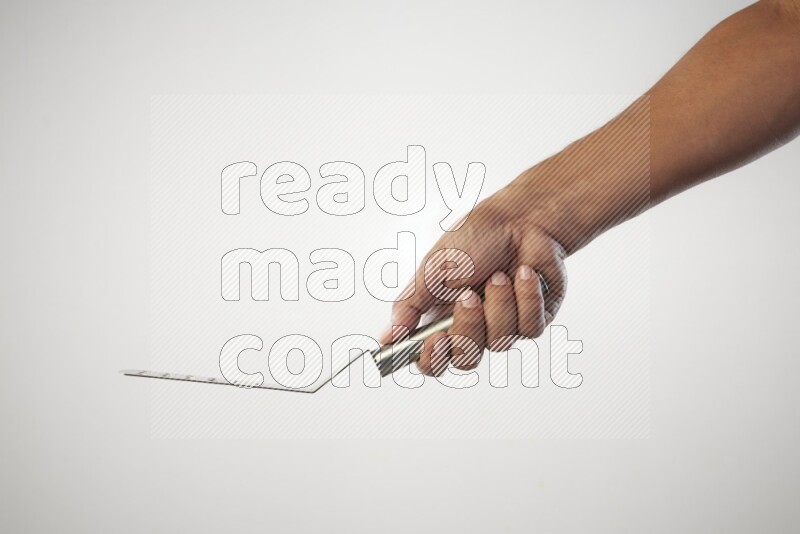 Male Hand Holding Burger Flipper on white background