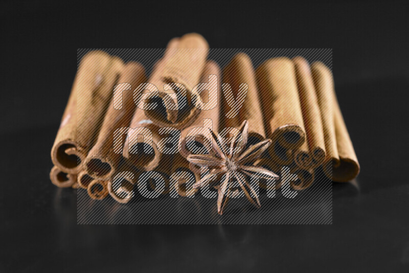 Cinnamon sticks and star anise on black background