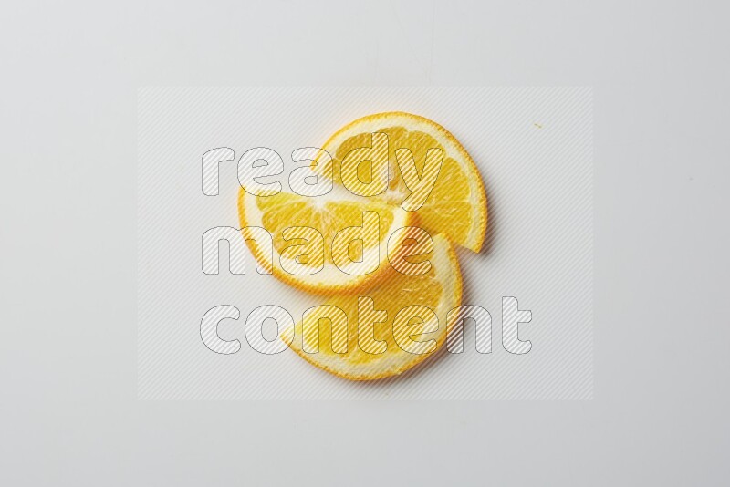 Three halves of an orange slices on white background