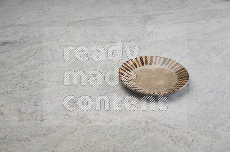 Multicolored Pottery Plate On Grey Marble Flooring