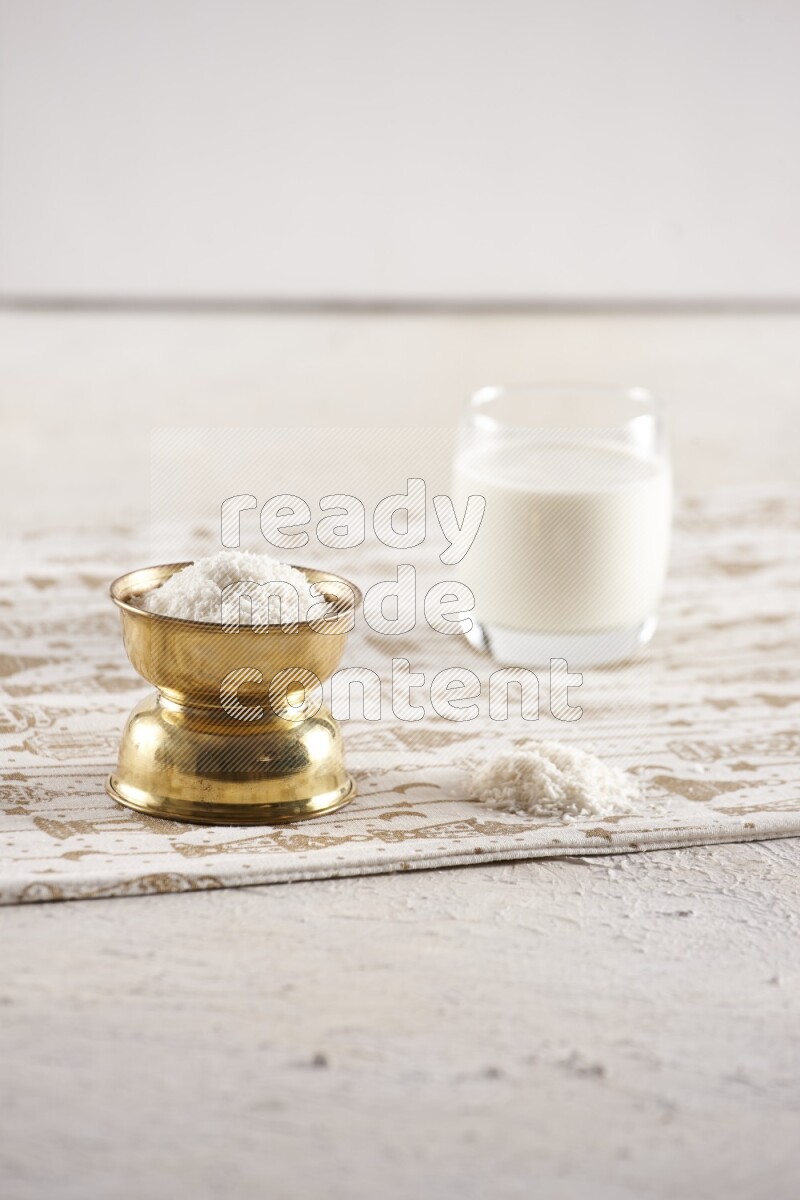 Dried fruits in a metal bowl with milk in a light setup