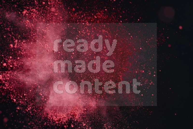 Red powder explosion on black background