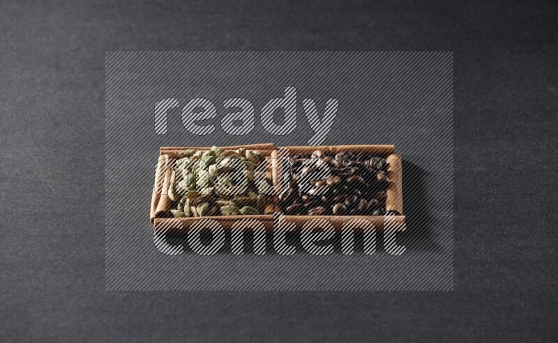 2 squares of cinnamon sticks full of coffee beans and cardamom on black flooring