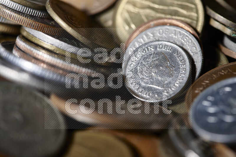A close-ups of random old coins on black background