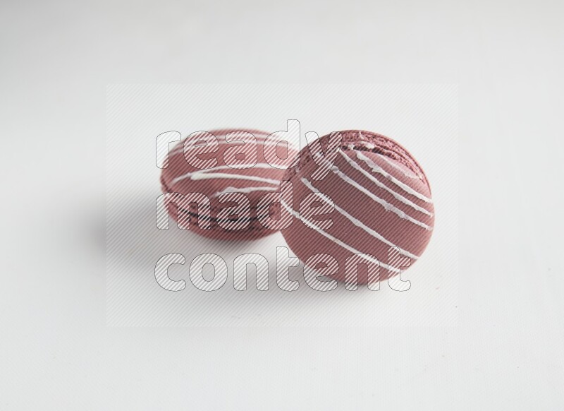 45º Shot of two Red Poppy Flower macarons on white background