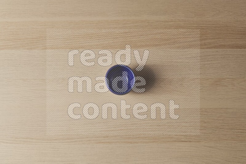 A pottery cup on light wooden background