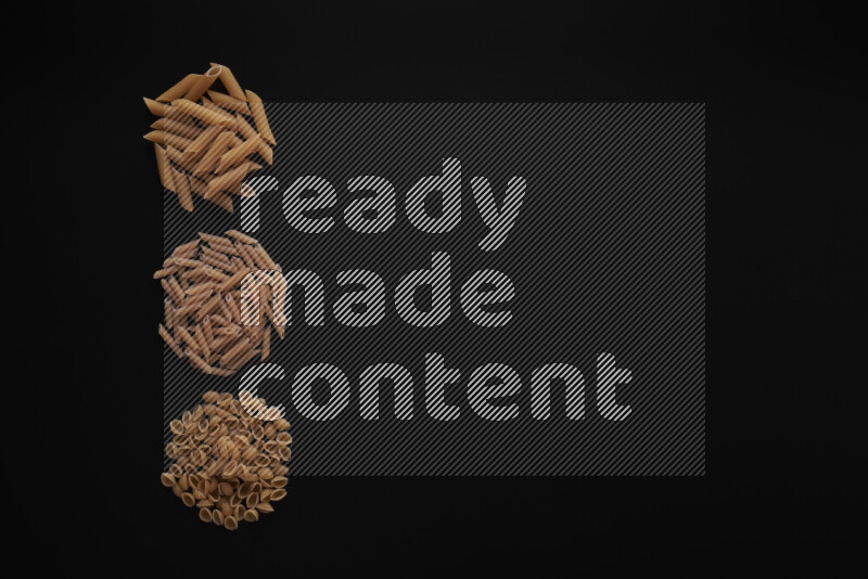 Different pasta types in 3 bunches on black background