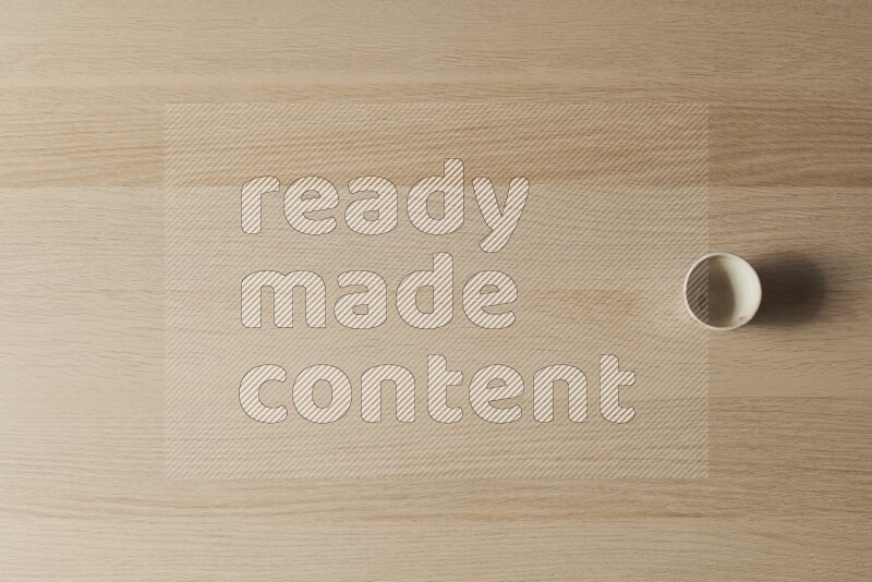 A pottery cup on light wooden background