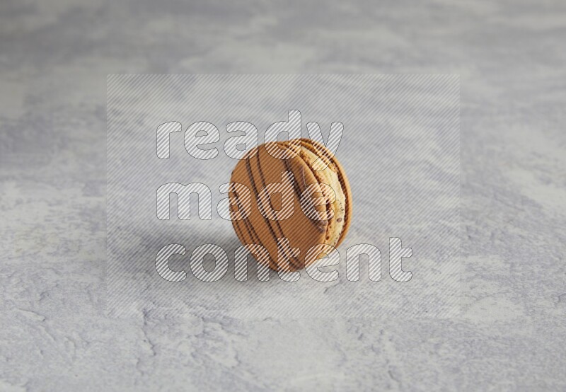 45º Shot of light brown  Almond Cream macaron on white  marble background