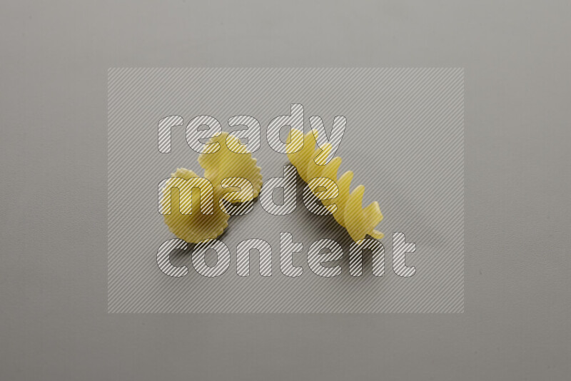 Fiocchi pasta with other types of pasta on grey background