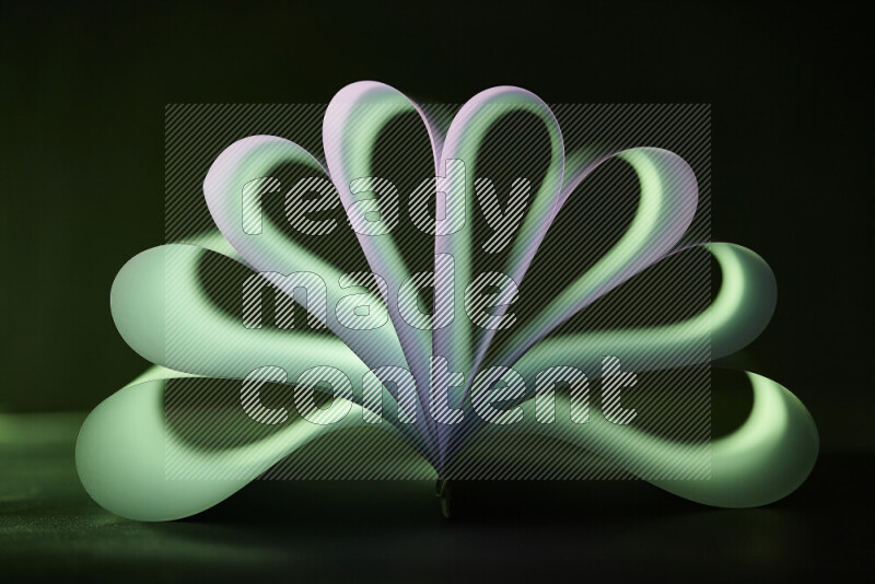 An abstract art piece displaying smooth curves in green and white gradients created by colored light
