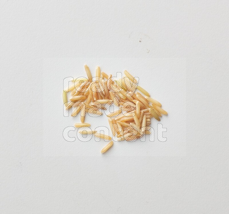 Top-view shot of long grain brown rice on white background