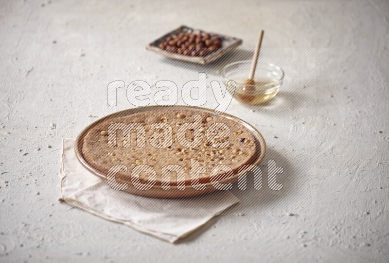 Basbousa with nuts and honey in a light setup
