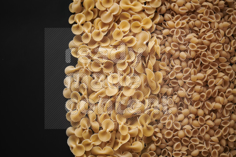 Different pasta types on black background