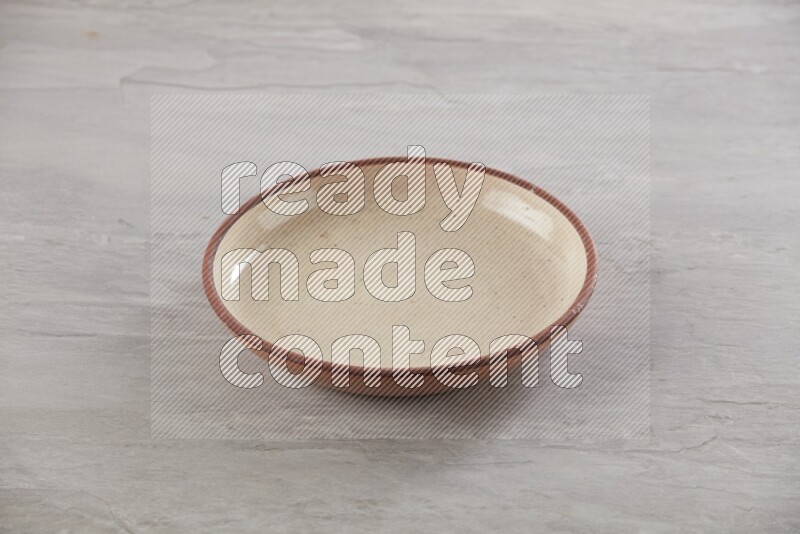 multi color ceramic round plate on grey textured countertop