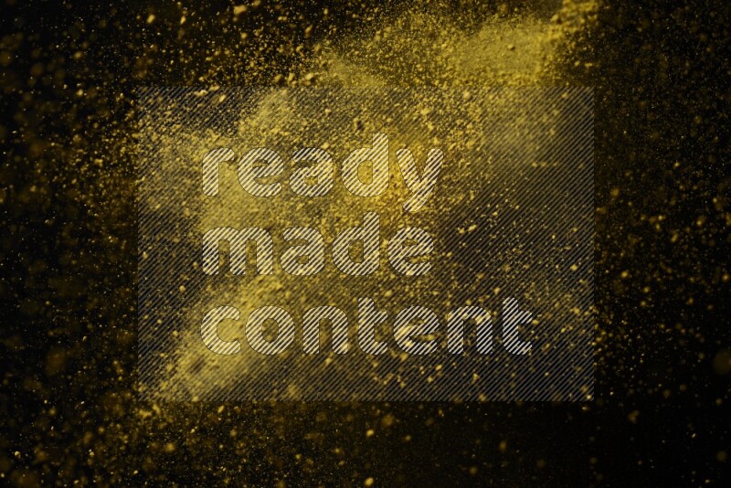 Yellow powder explosion on black background