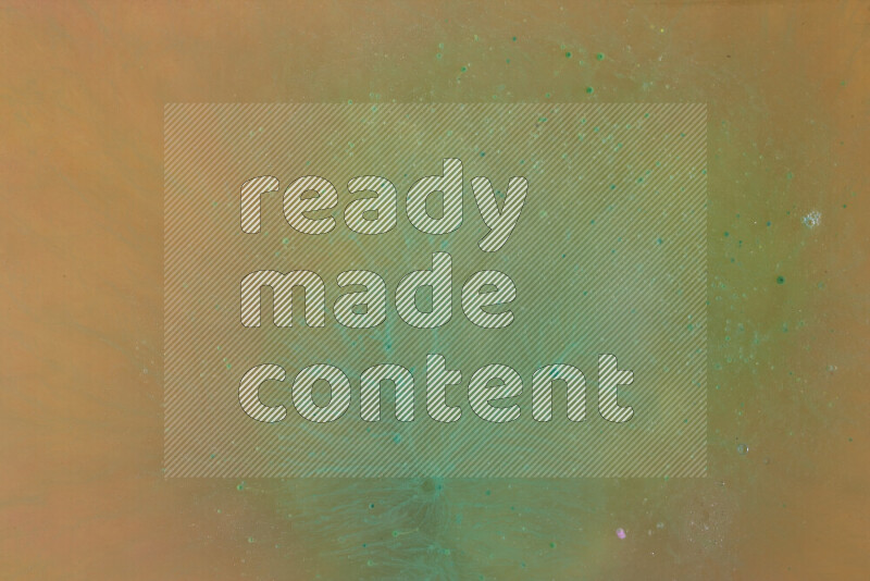 The image captures a dramatic splatter of green paint over a orange backdrop