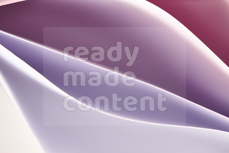 هذه الصورة تعرض تكوين فن الورق التجريدي مع منحنيات ورقية باللون الأبيض ودرجات دافئة مختلفة المكونه بواسطة الضوء الملون