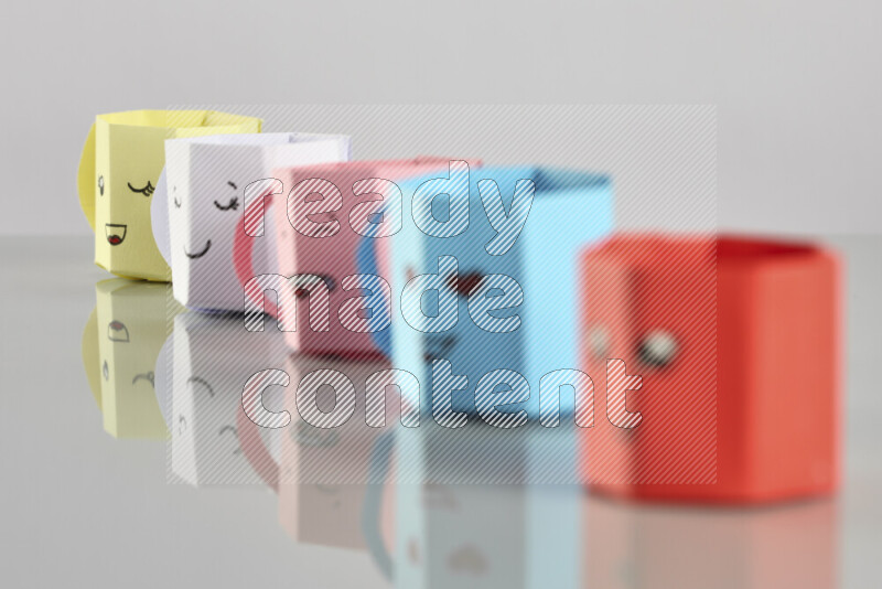 Origami cup on grey background