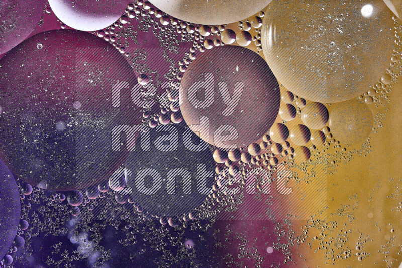 Close-ups of abstract oil bubbles on water surface in shades of yellow, purple and pink