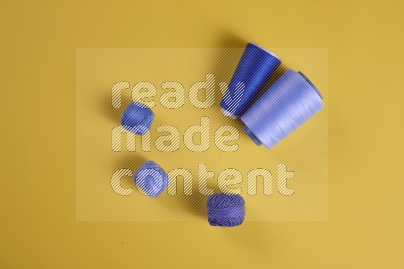 A blue collection of sewing and tailoring tools arranged on a yellow background