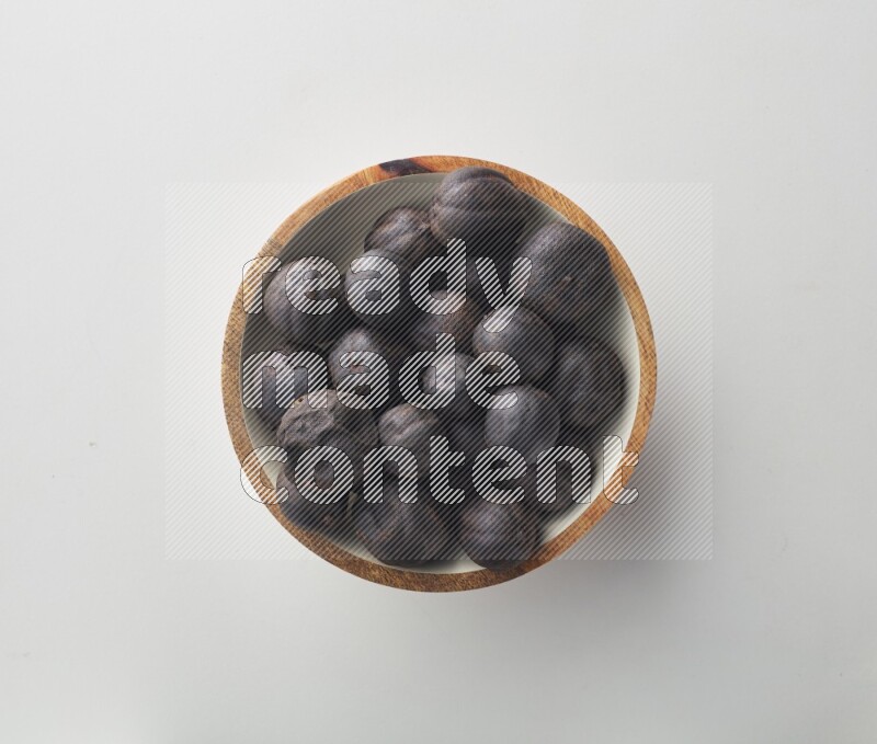 Top-view shot of dried lime (loomi) in a container on white background