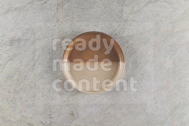 A multicolored pottery oven bowl on grey marble background