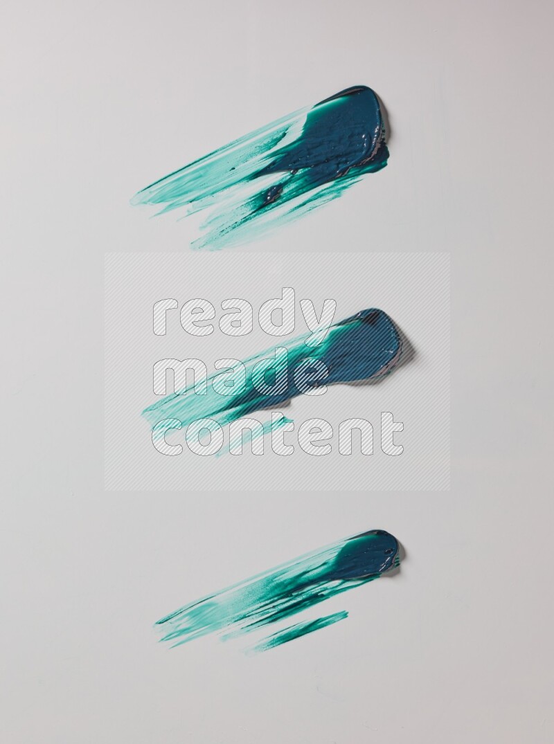 Turquoise painting knife strokes on white background
