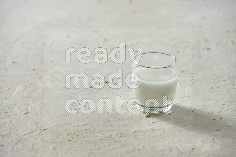 Cold drinks in a glass cup such as water, tamarind, qamar eldin, sobia, milk and hibiscus on textured white background