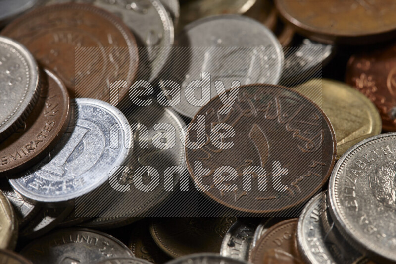 A close-ups of random old coins on black background
