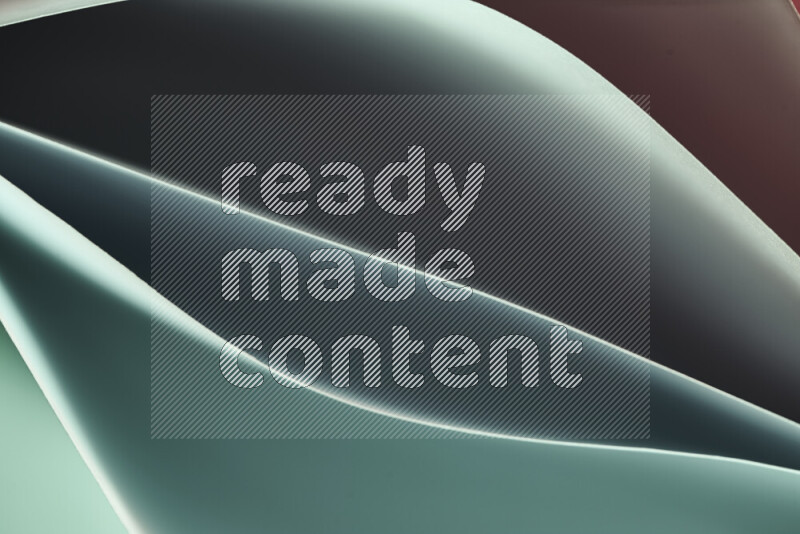 This image showcases an abstract paper art composition with paper curves in green and red gradients created by colored light