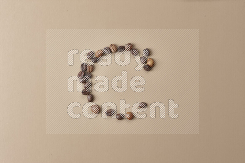 Roasted coffee beans on beige background