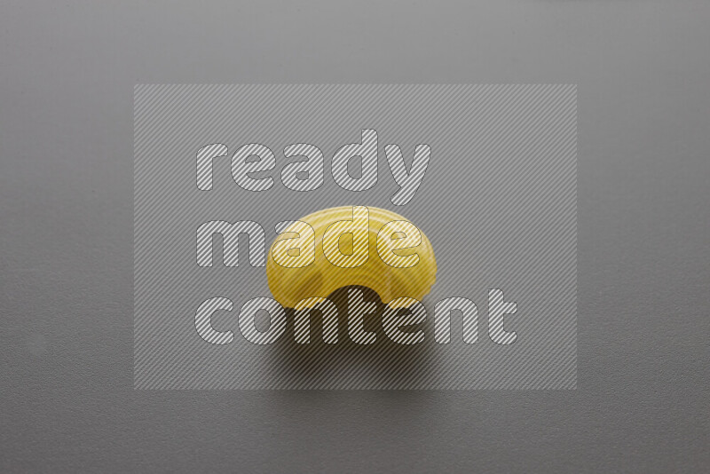 Elbow pasta on grey background