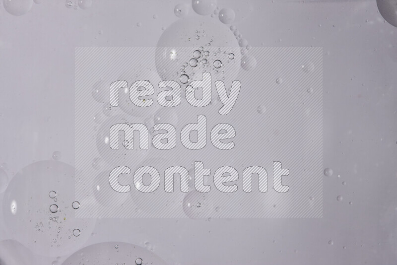 Abstract oil droplets in a water surface on white background