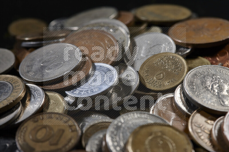 A close-ups of random old coins on black background