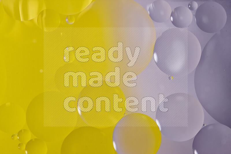 Close-ups of abstract oil bubbles on water surface in shades of white and yellow