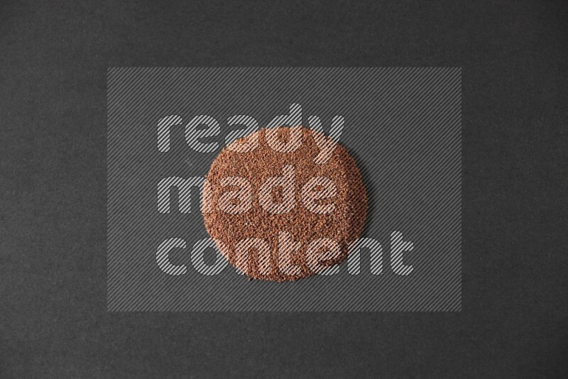 Garden cress seeds in a circle shape on a black flooring