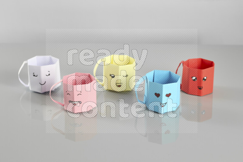 Origami cup on grey background