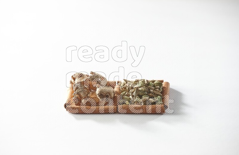 2 squares of cinnamon sticks full of cardamom and dried ginger on white flooring