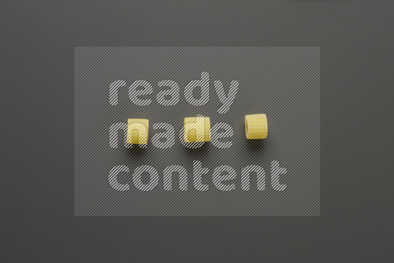 Big rings pasta on grey background