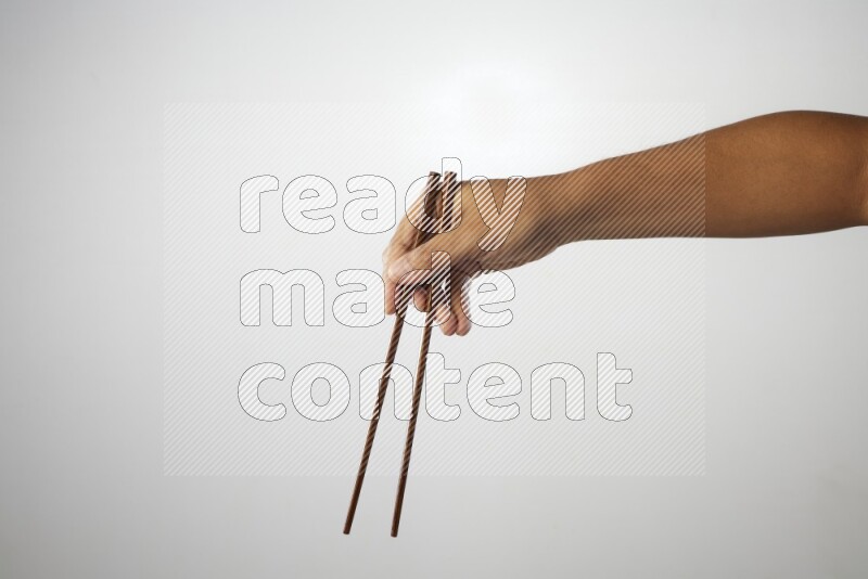 Male Hand Holding Chop Stick on white background