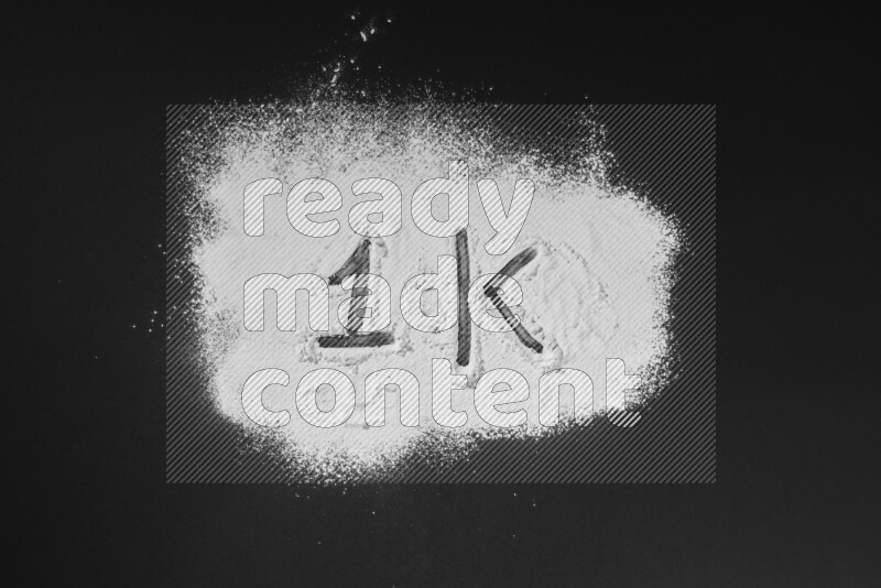 Numbers written with powder on black background