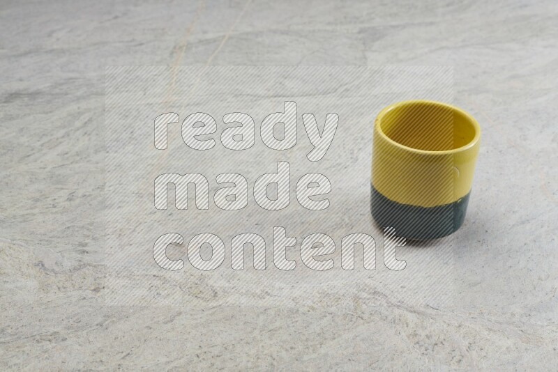 A multicolored pottery Cup on grey marble background