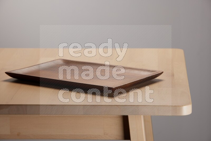 wooden trays and cutting boards on the edge of wooden table