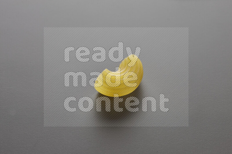 Elbow pasta on grey background