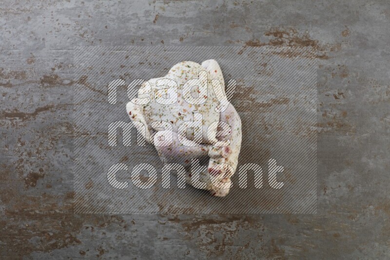 whole raw chicken  direct on a rustic grey background