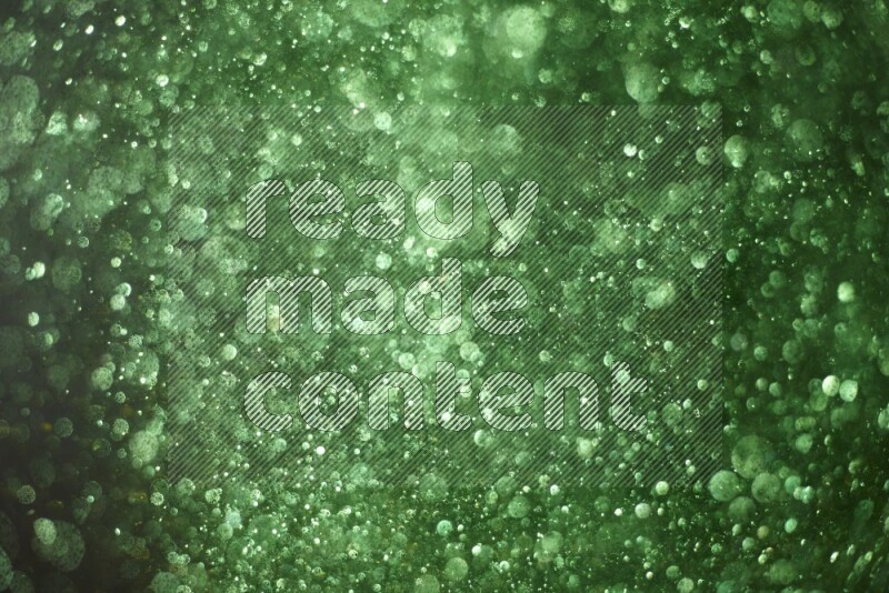 Green glitter powder isolated on black background