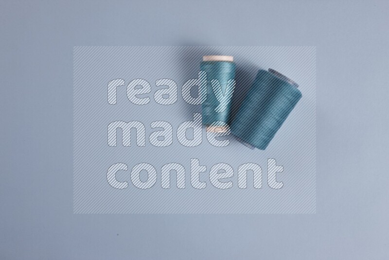 A blue collection of sewing and tailoring tools arranged on a blue background