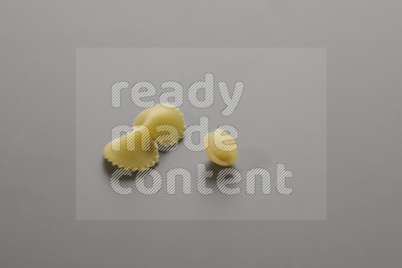 Fiocchi pasta with other types of pasta on grey background